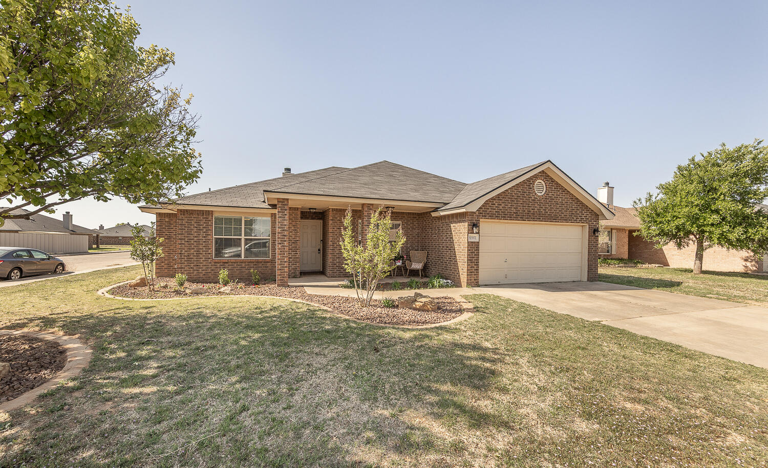 6901 9th Street Lubbock, TX 79416 - Photo 27 of 27 a front view of a house with a yard and garage