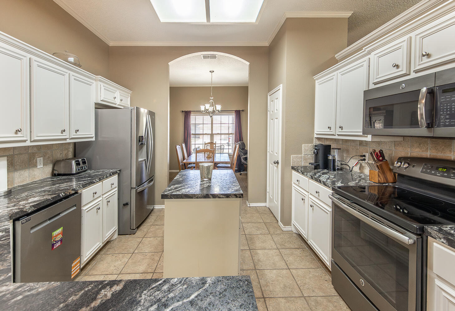 6901 9th Street Lubbock, TX 79416 - Photo 3 of 27 a large kitchen with stainless steel appliances granite countertop a stove sink and cabinets