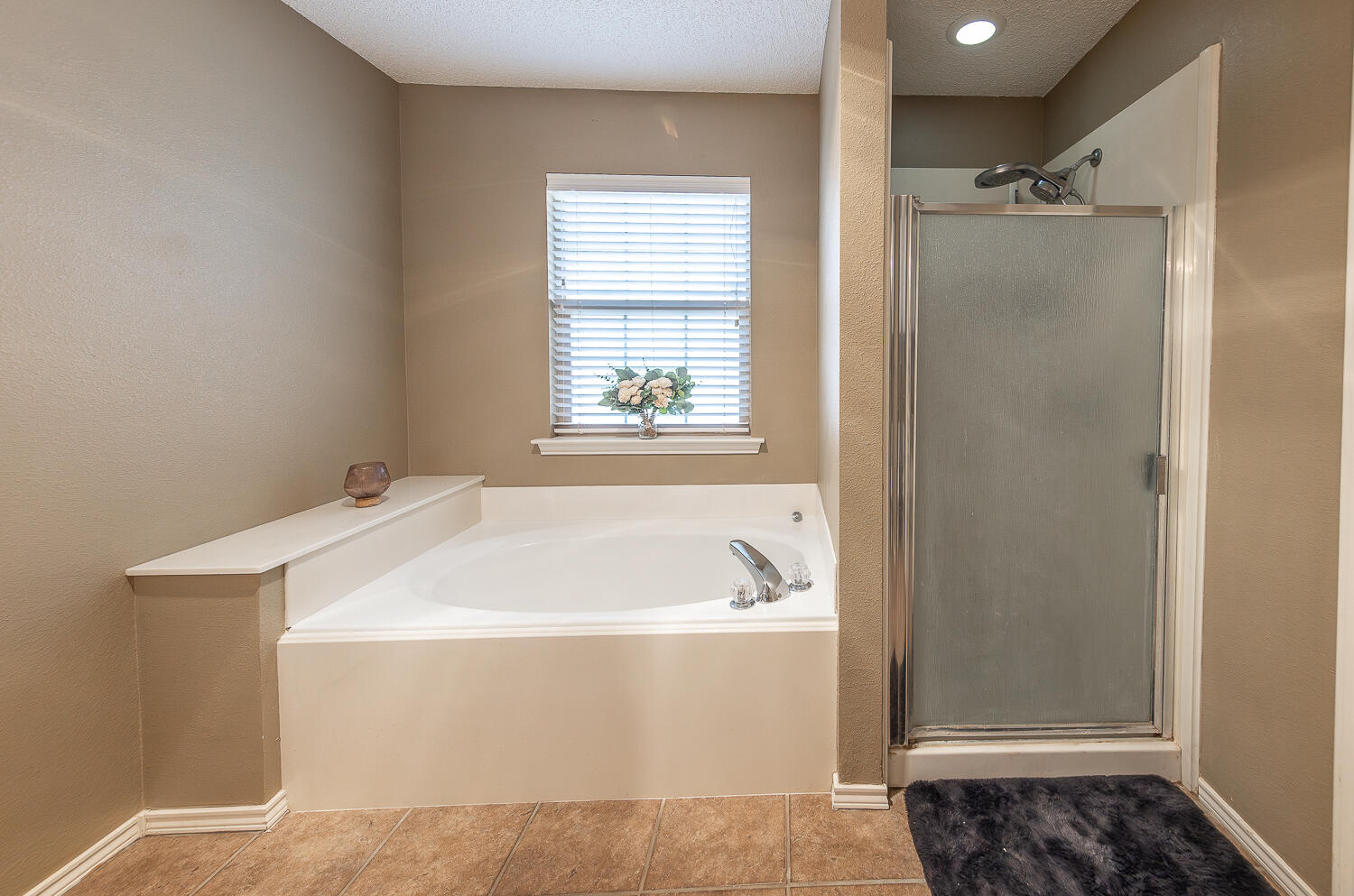 6901 9th Street Lubbock, TX 79416 - Photo 6 of 27 a bathroom with a bathtub and a shower