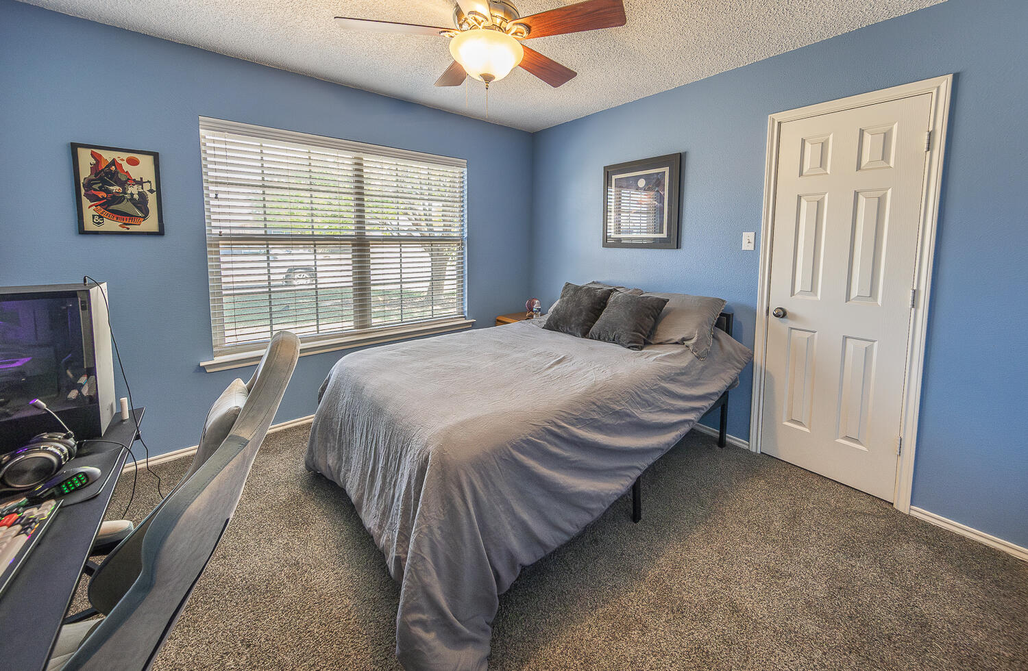 6901 9th Street Lubbock, TX 79416 - Photo 7 of 27 a bedroom with a bed window and flat screen tv