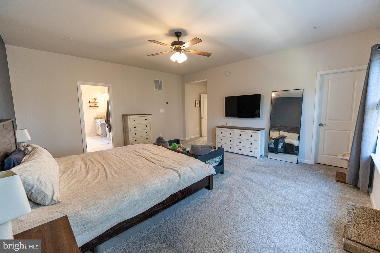 43907 Monterey Street California, MD 20619 - Photo 55 of 95 a bedroom with a large bed and a tv