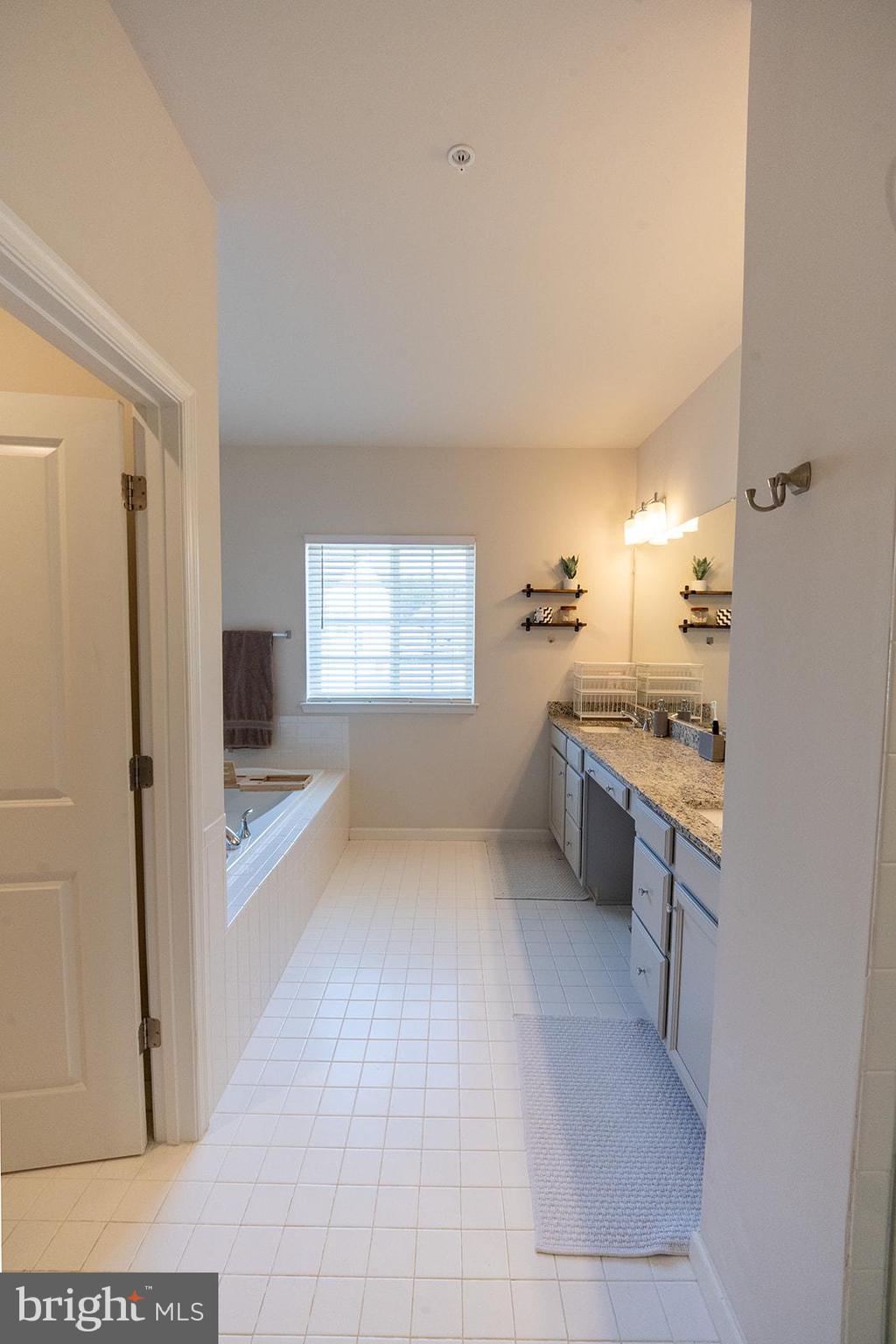 43907 Monterey Street California, MD 20619 - Photo 65 of 95 a large white kitchen with a sink and dishwasher with a large window
