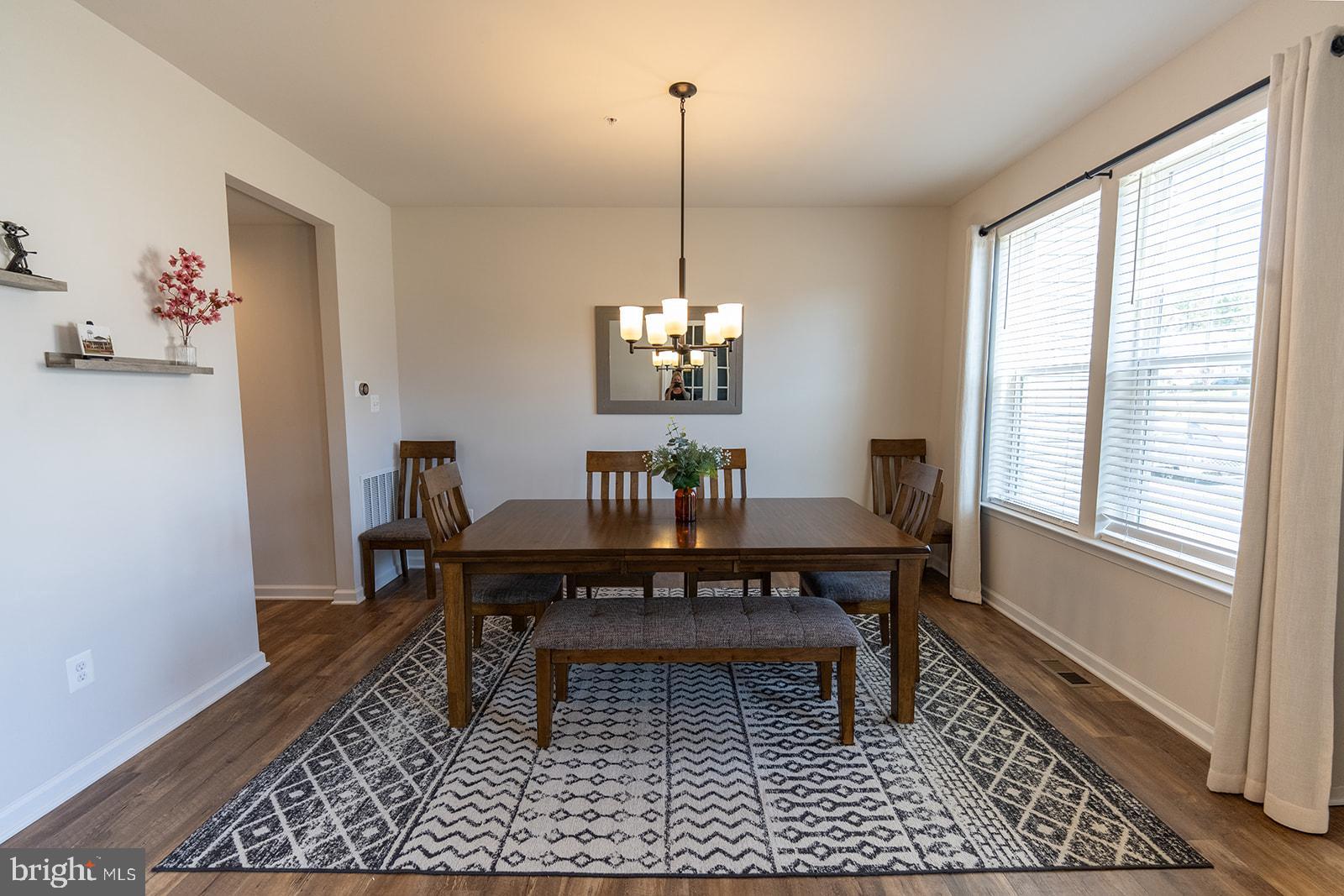 43907 Monterey Street California, MD 20619 - Photo 7 of 95 a view of a dining room with furniture window and wooden floor