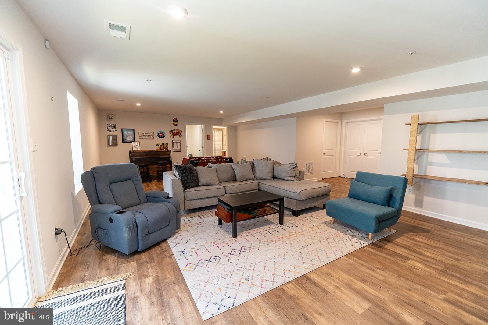 43907 Monterey Street California, MD 20619 - Photo 79 of 95 a living room with furniture and a wooden floor