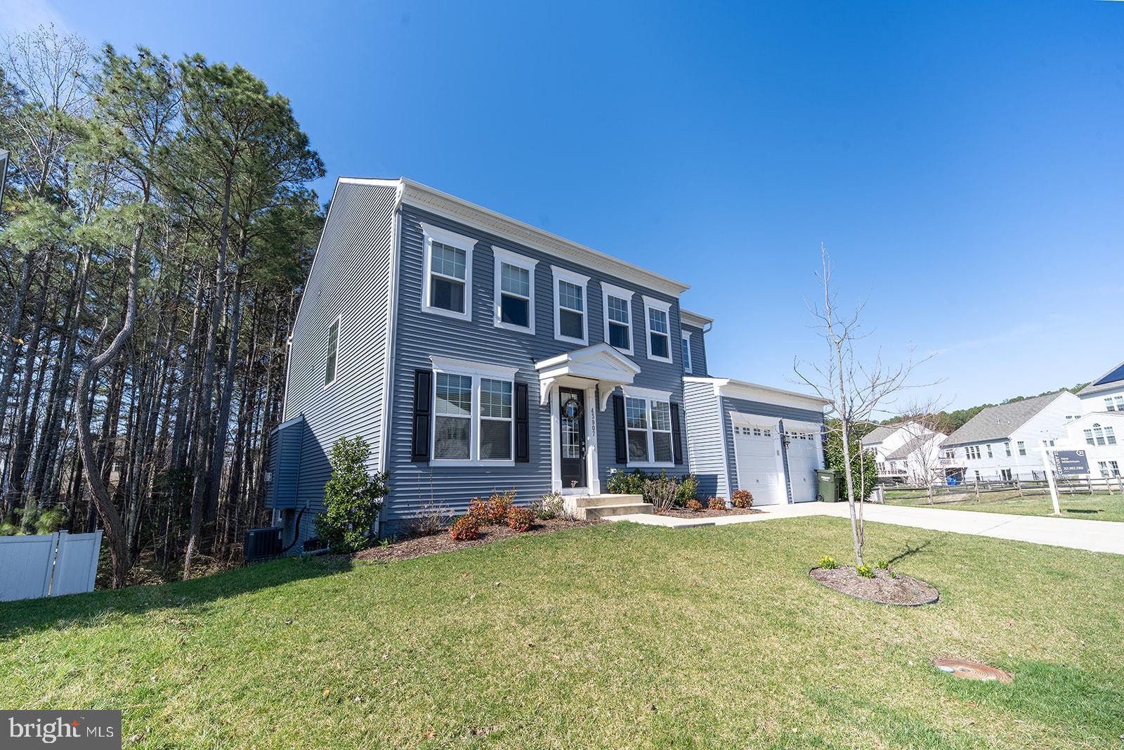 43907 Monterey Street California, MD 20619 - Photo 95 of 95 a front view of a house with a yard
