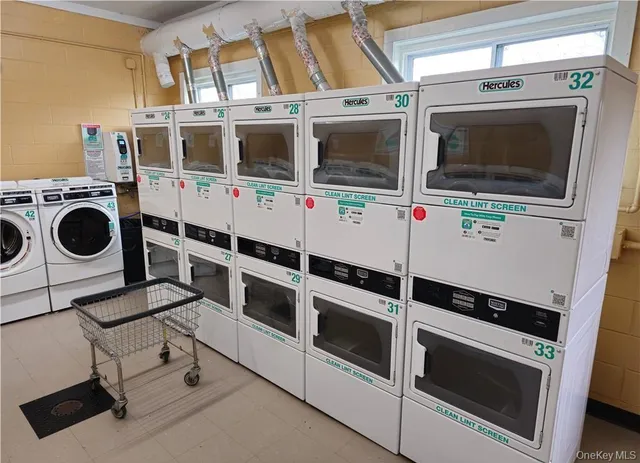 a utility room with stainless steel appliances and cabinets