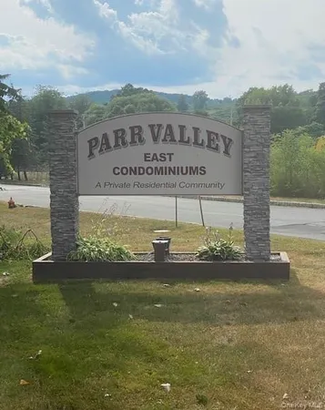 a view of a garden with a building in the background