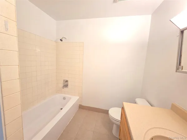 a bathroom with a bathtub and toilet