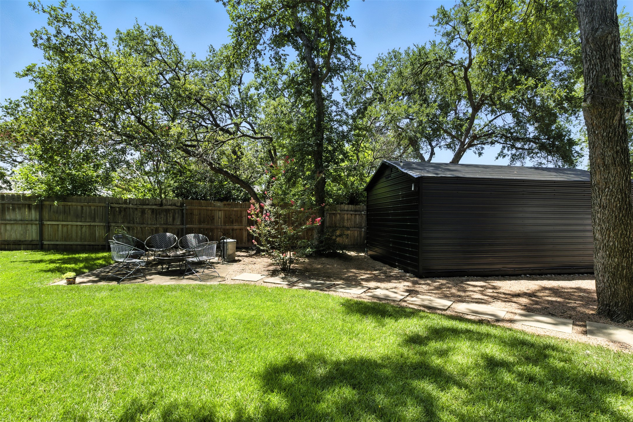 2403 Gateshead Circle Austin, TX 78745 - Photo 20 of 22 A verdant backyard retreat features a private patio and a robust storage shed.