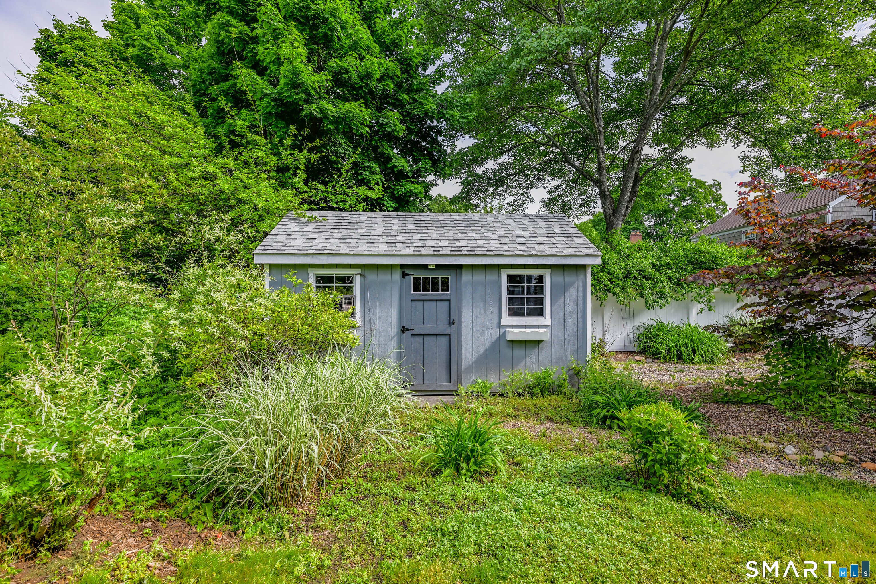 47 Spring Lane West Hartford, CT 06107 - Photo 35 of 38 a view of a house with potted plants and large trees
