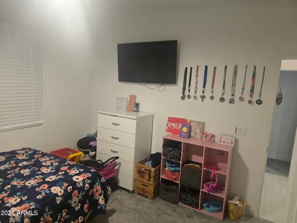 a bedroom with a bed and flat screen tv