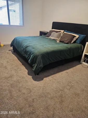 a bedroom with a bed and window