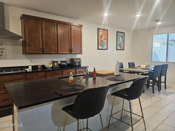 a kitchen with a dining table and chairs