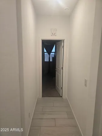 a view of a hallway to a hallway