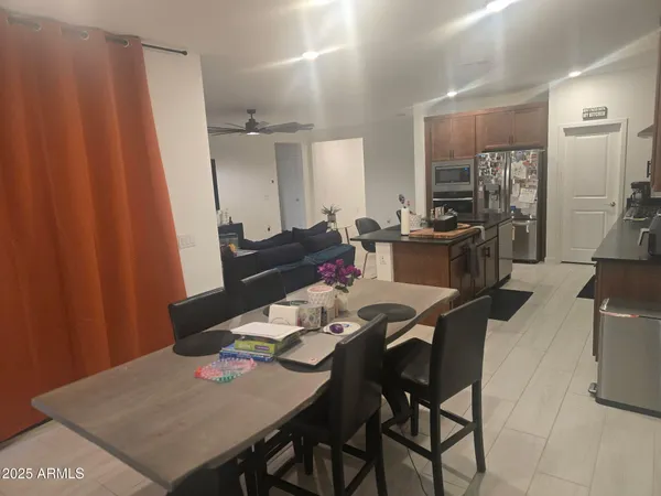 a dining room with furniture and wooden floor