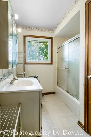 a bathroom with a sink and a mirror