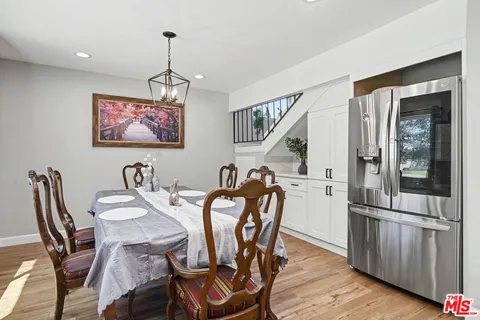 a large kitchen with a table and chairs