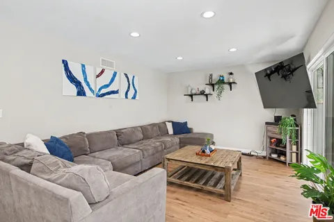 a bed room with a bed and a potted plant