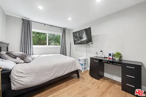 a bedroom with a bed and a couch