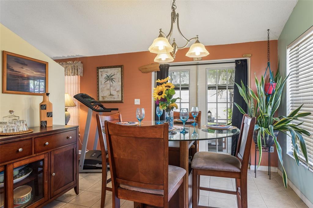 502 Avocado Circle Brandon, FL 33510 - Photo 12 of 50 a dining room with furniture a chandelier and window