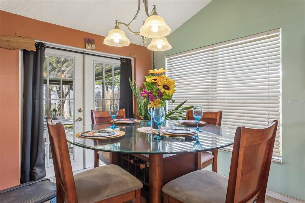 502 Avocado Circle Brandon, FL 33510 - Photo 13 of 50 a view of a dining room with furniture wooden floor and chandelier