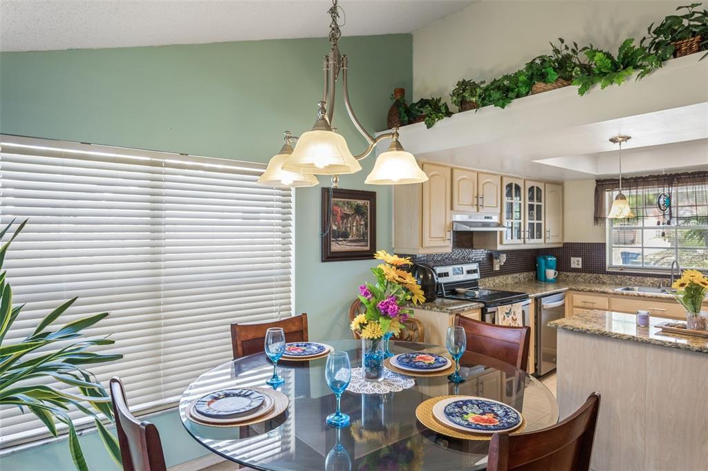 502 Avocado Circle Brandon, FL 33510 - Photo 18 of 50 a kitchen with a sink a stove and chairs