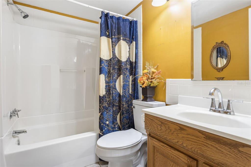 502 Avocado Circle Brandon, FL 33510 - Photo 25 of 50 a bathroom with a granite countertop sink toilet and shower