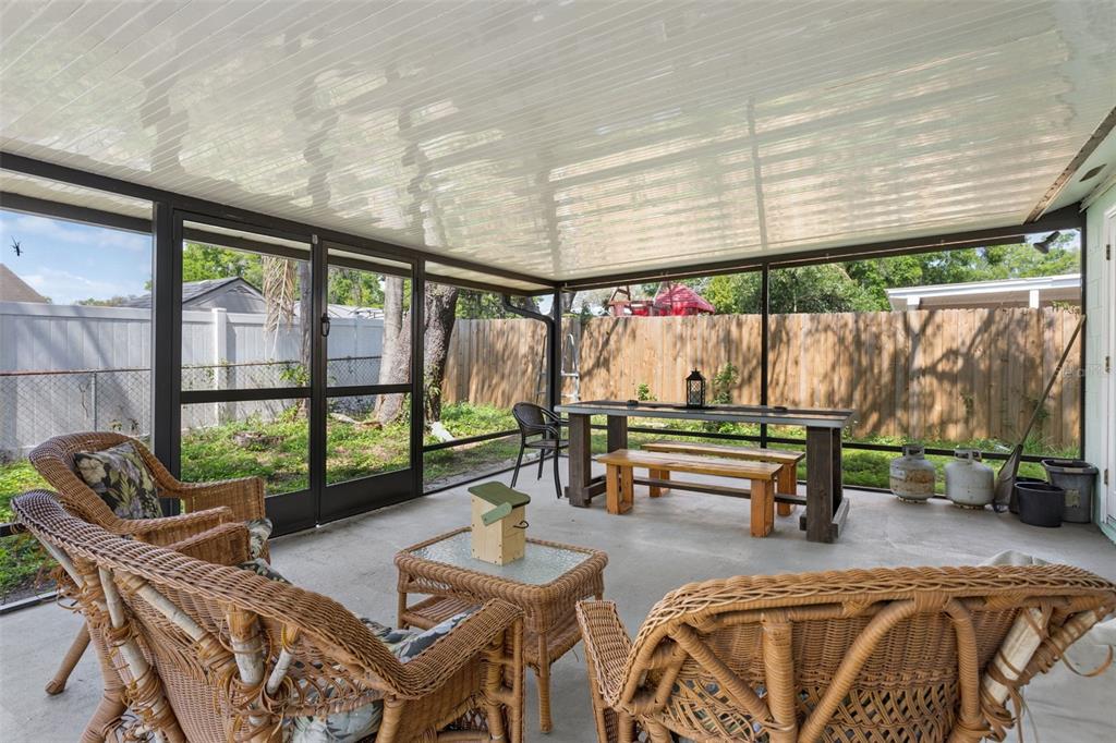 502 Avocado Circle Brandon, FL 33510 - Photo 39 of 50 a living room with patio furniture and a floor to ceiling window