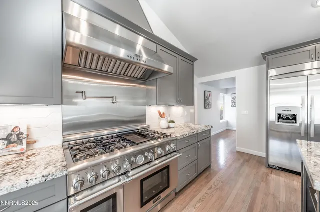 a kitchen with stainless steel appliances granite countertop a stove and a refrigerator
