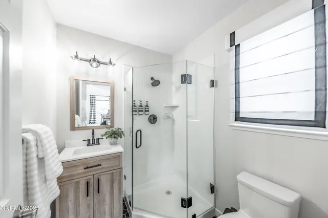 a bathroom with a shower a sink and a mirror