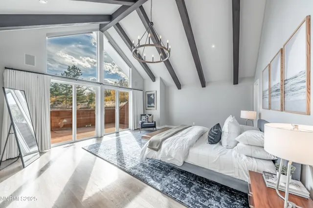 a bedroom with a large bed and a large window with outer view