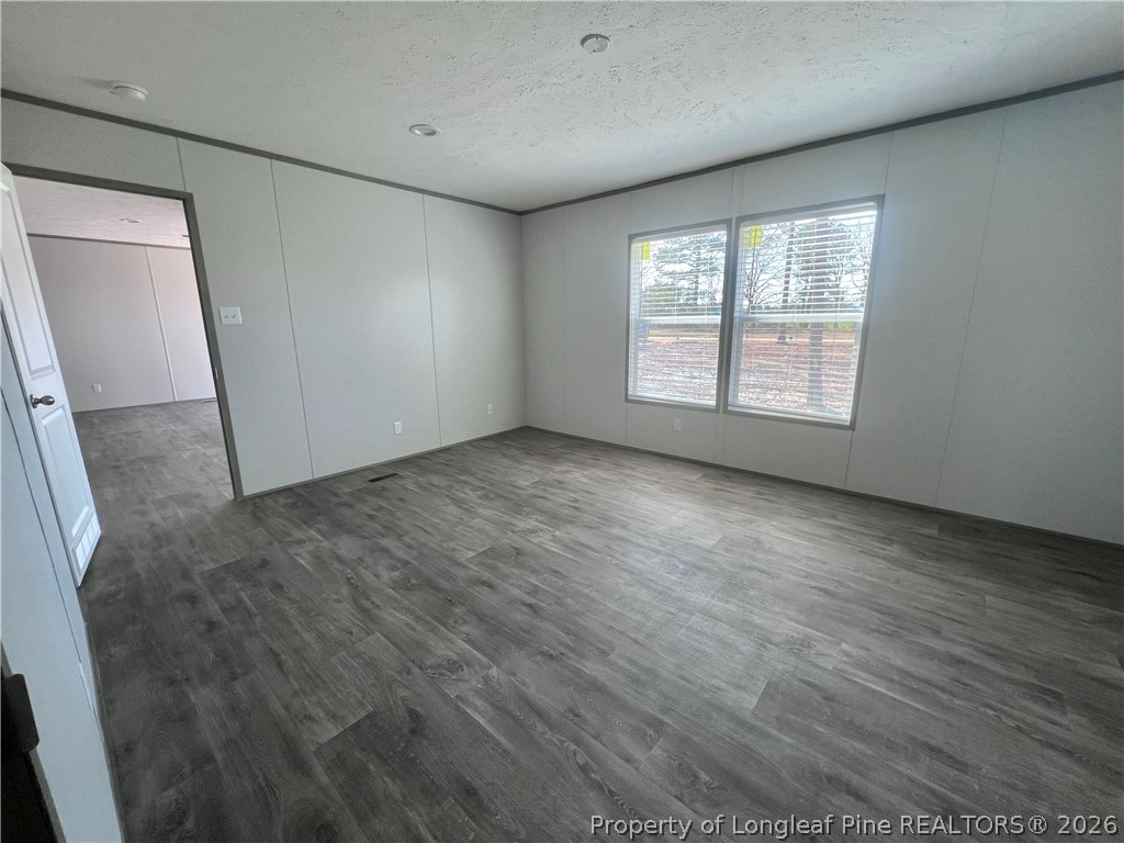 1452 Mercer Mill Road Lumberton, NC 28358 - Photo 13 of 17 a view of an empty room with wooden floor and a window