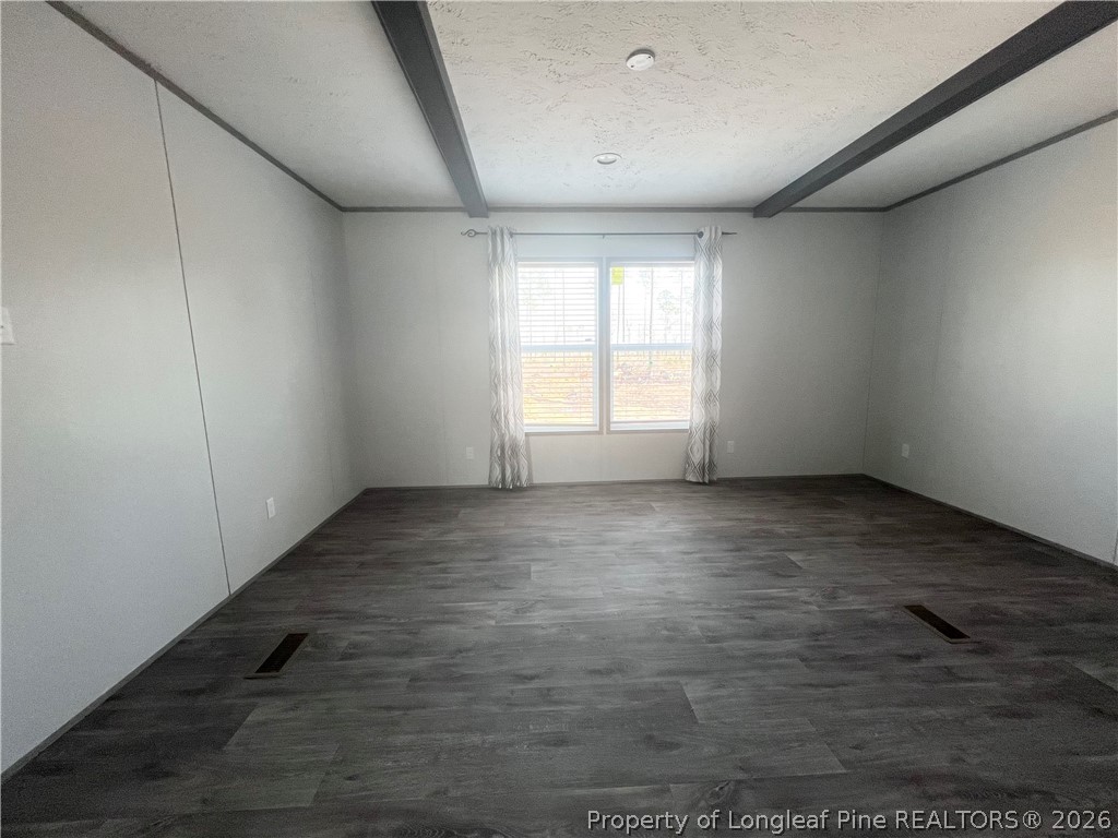 1452 Mercer Mill Road Lumberton, NC 28358 - Photo 13 of 19 an empty room with wooden floor and windows