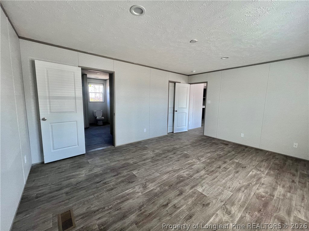 1452 Mercer Mill Road Lumberton, NC 28358 - Photo 14 of 17 a view of empty room with wooden floor