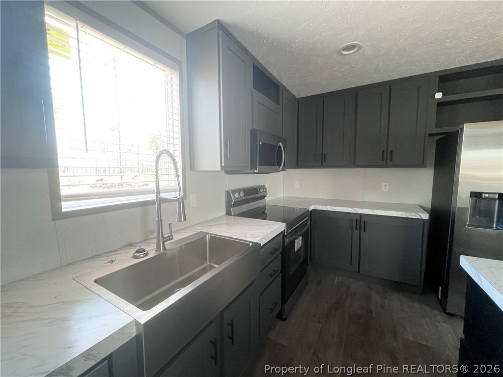 1452 Mercer Mill Road Lumberton, NC 28358 - Photo 18 of 19 a kitchen that has a sink cabinets counter space and appliances