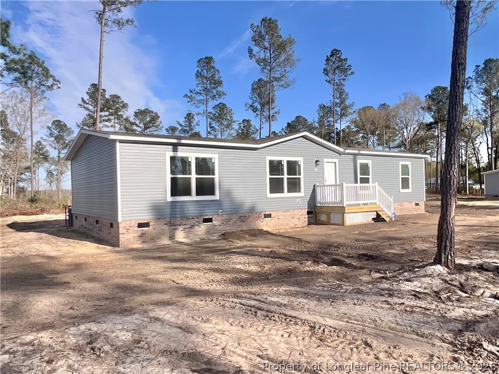 1452 Mercer Mill Road Lumberton, NC 28358 - Photo 3 of 19 a view of a house with a backyard