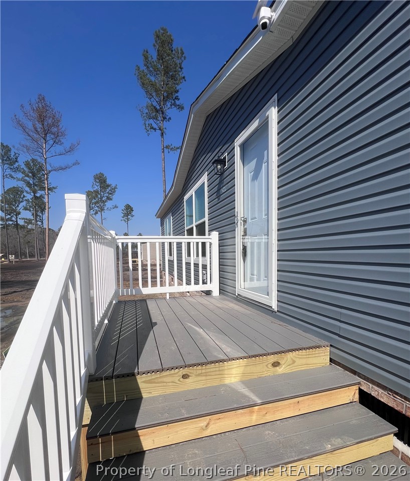 1452 Mercer Mill Road Lumberton, NC 28358 - Photo 5 of 19 a view of a house with backyard and deck