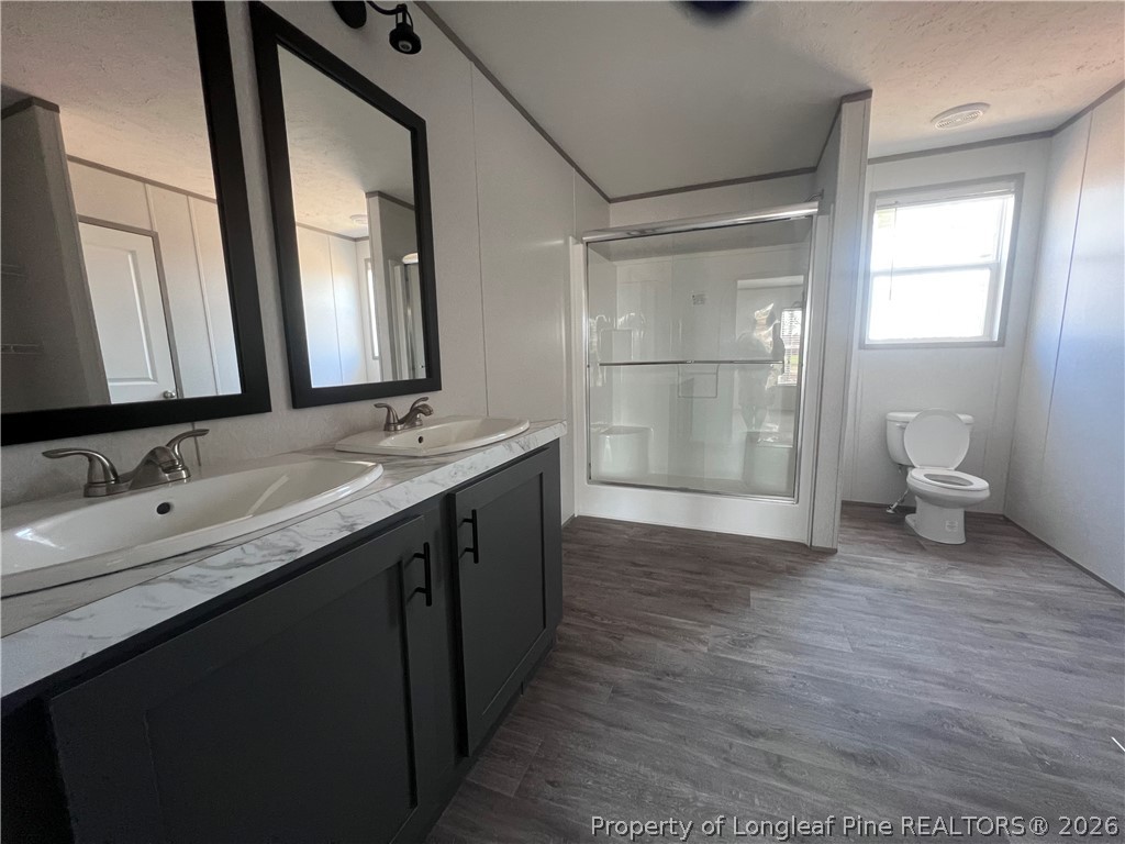 1452 Mercer Mill Road Lumberton, NC 28358 - Photo 7 of 17 a bathroom with a double vanity sink mirror and toilet