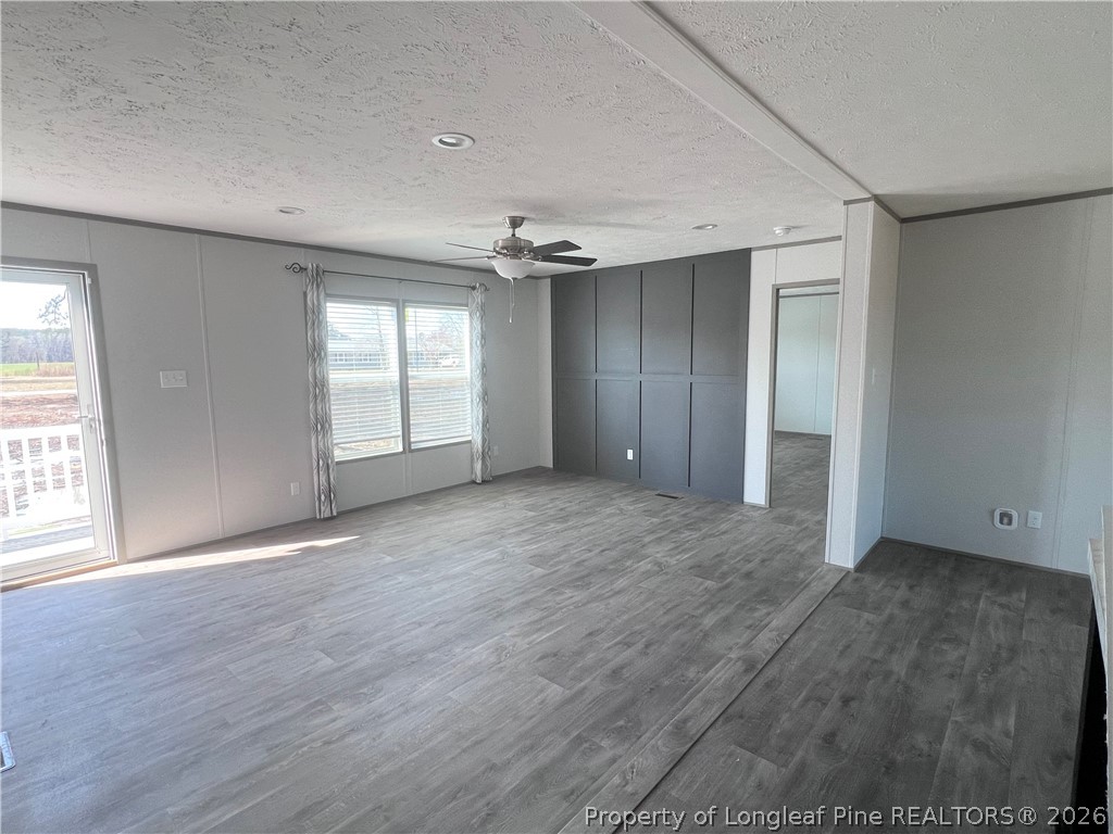 1452 Mercer Mill Road Lumberton, NC 28358 - Photo 7 of 19 an empty room with wooden floor and windows