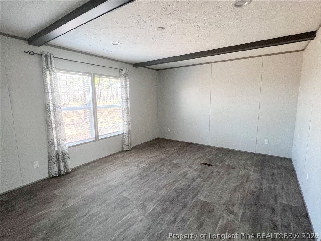 1452 Mercer Mill Road Lumberton, NC 28358 - Photo 8 of 19 a view of an empty room with wooden floor and a window