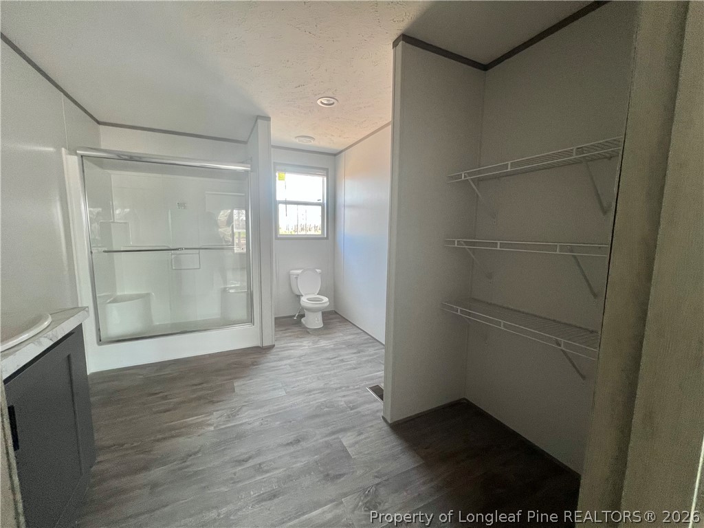 1452 Mercer Mill Road Lumberton, NC 28358 - Photo 8 of 17 a bathroom with a glass shower door