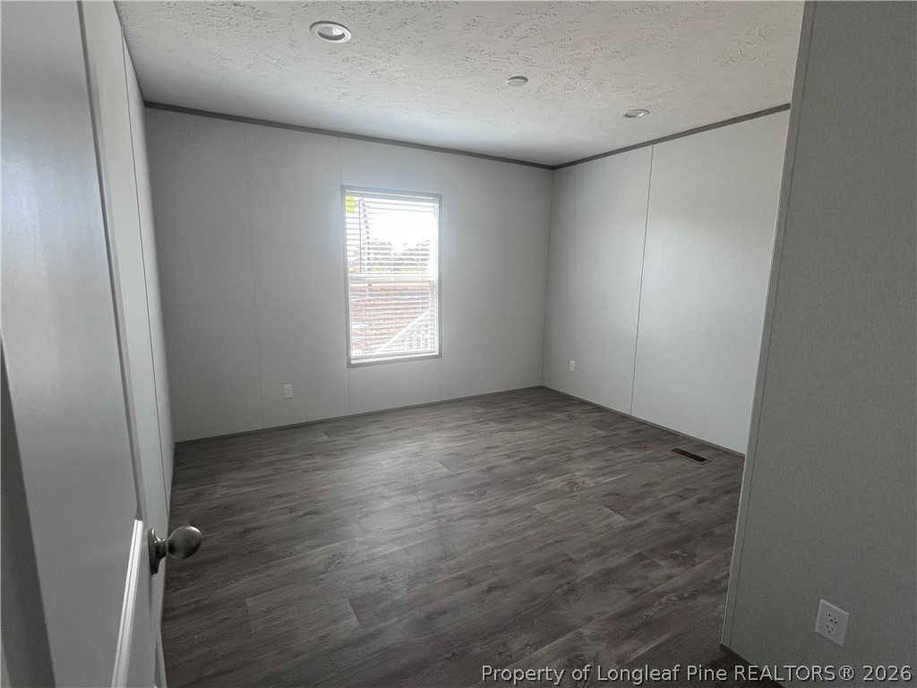 1452 Mercer Mill Road Lumberton, NC 28358 - Photo 9 of 17 an empty room with a empty space and windows