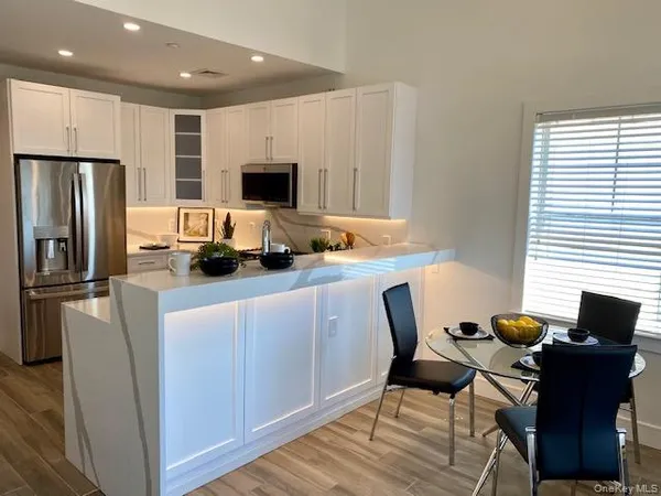 a kitchen with stainless steel appliances a refrigerator and a stove top oven