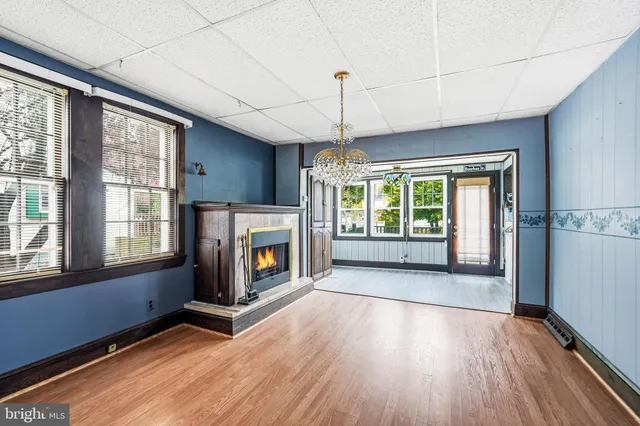 a view of an empty room with a fireplace and a window