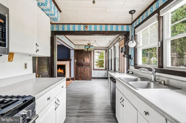 a kitchen with granite countertop a sink and a stove