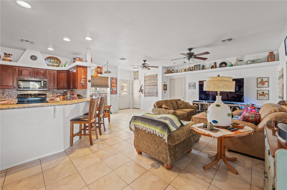 14105 Cactus Road Yucca, AZ 86438 - Photo 11 of 47 a living room with lots of furniture and kitchen view
