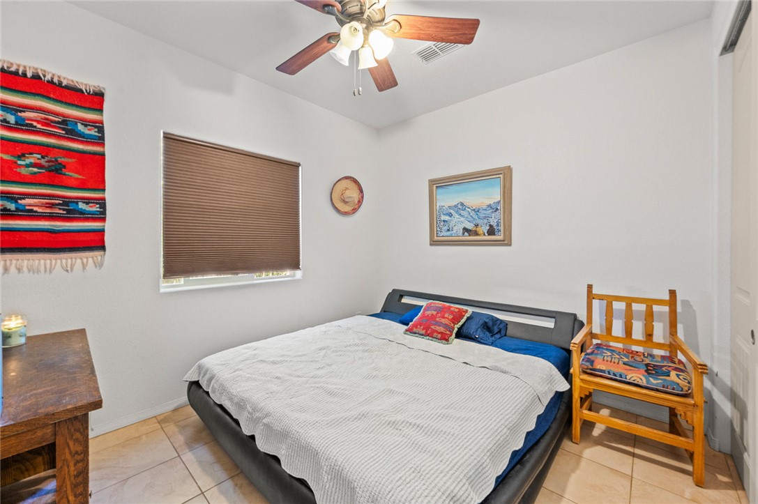 14105 Cactus Road Yucca, AZ 86438 - Photo 23 of 47 a bedroom with a bed and a painting on the wall