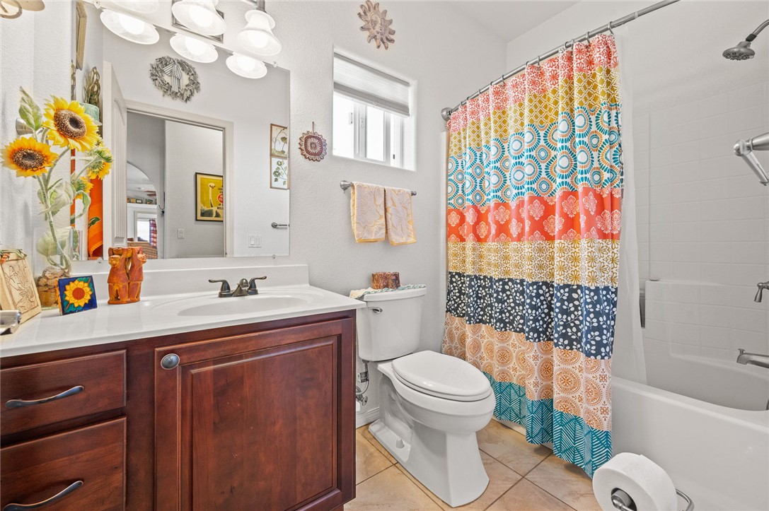 14105 Cactus Road Yucca, AZ 86438 - Photo 24 of 47 a bathroom with a sink a toilet and shower curtain