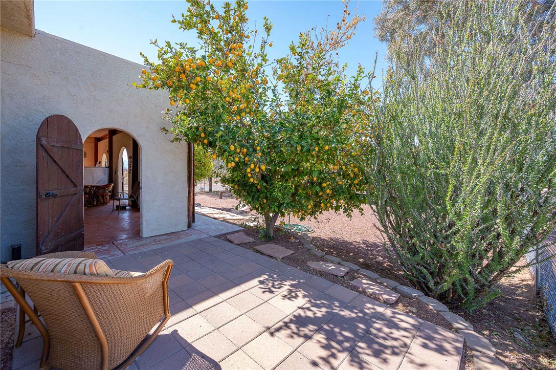 14105 Cactus Road Yucca, AZ 86438 - Photo 29 of 47 a backyard of a house with table and chairs