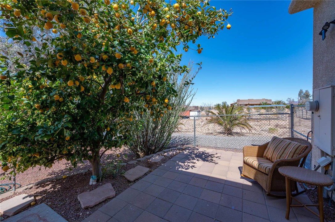 14105 Cactus Road Yucca, AZ 86438 - Photo 30 of 47 a view of a backyard with sitting area